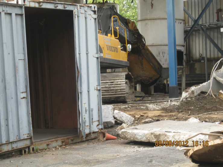 a yellow construction vehicle in a storage area