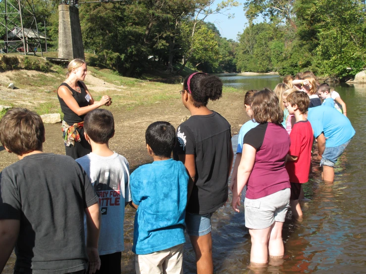 some young people and an adult in the water