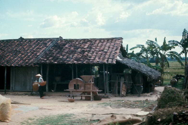 a thatch roof hut with a bricked front entrance and porch