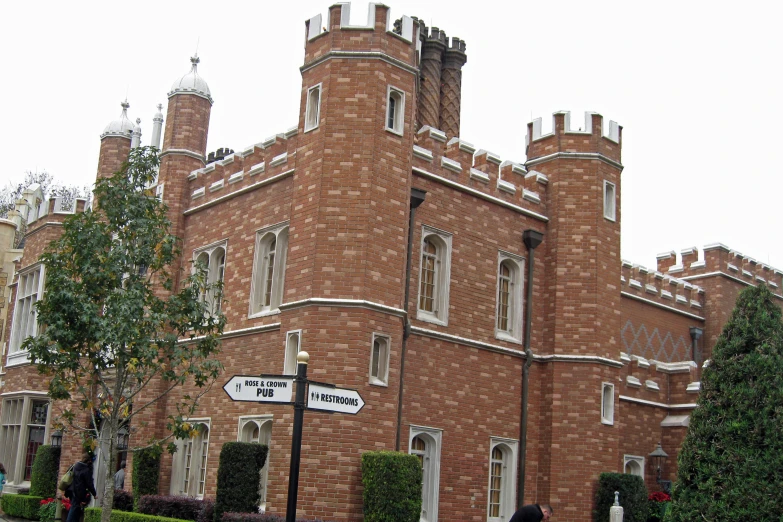 a tall brick building with windows and several turrets on top of it