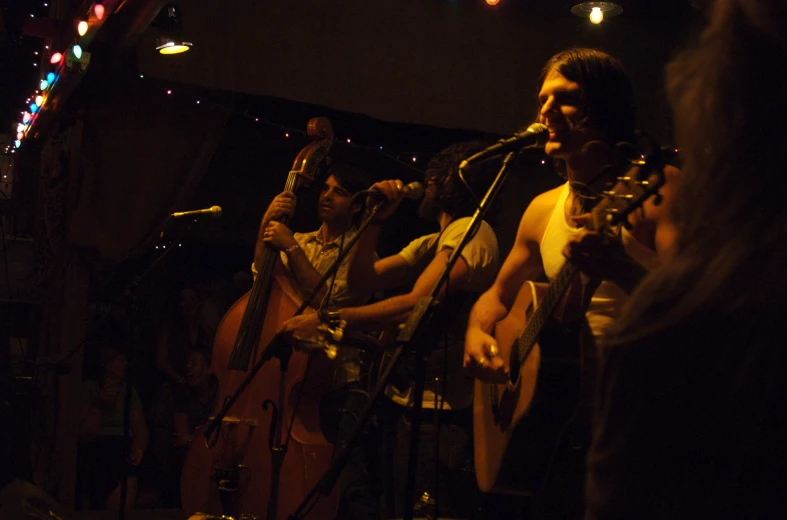 people are performing with guitars at night