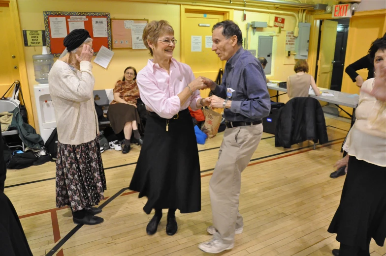 people on a wood floor are dancing