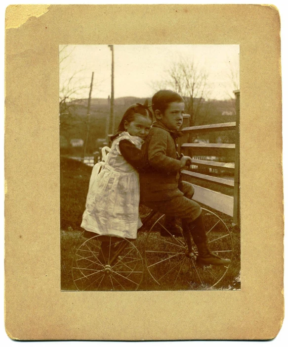 the old po of a little boy and girl cuddle on a bench