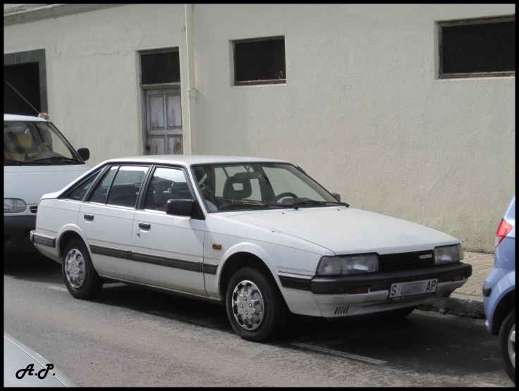 a car parked next to a building on a side walk