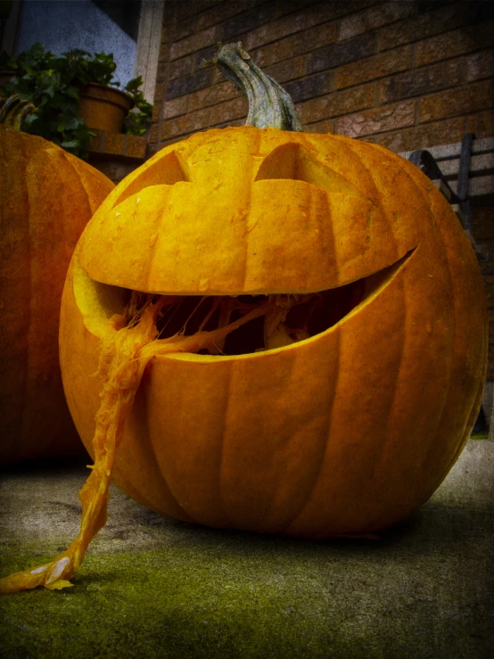 two large pumpkins decorated as heads and mouths