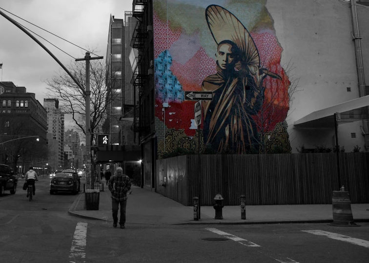 a street scene with people walking by a mural on a building