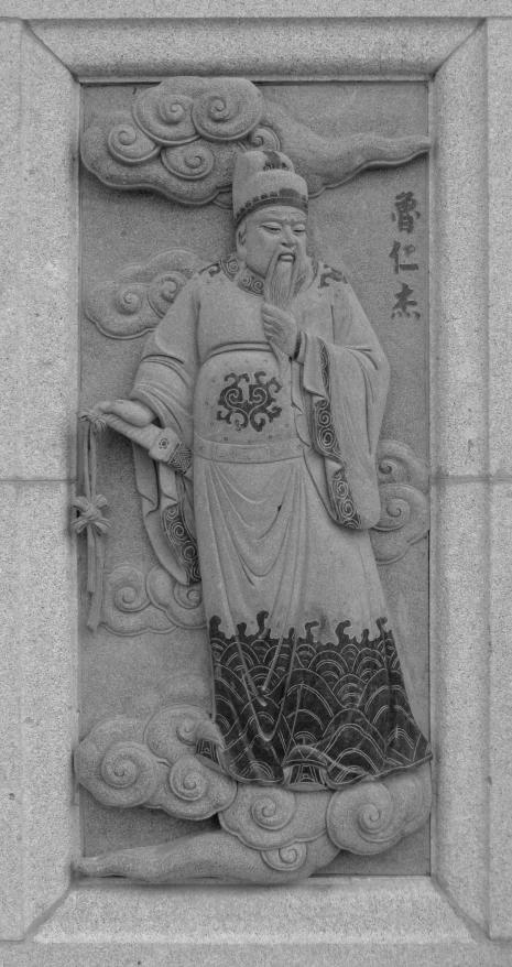 a black and white po of a statue in front of a building