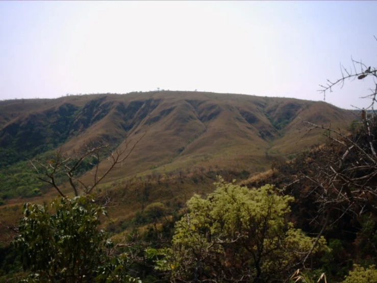 a mountain landscape with trees and mountains in the distance