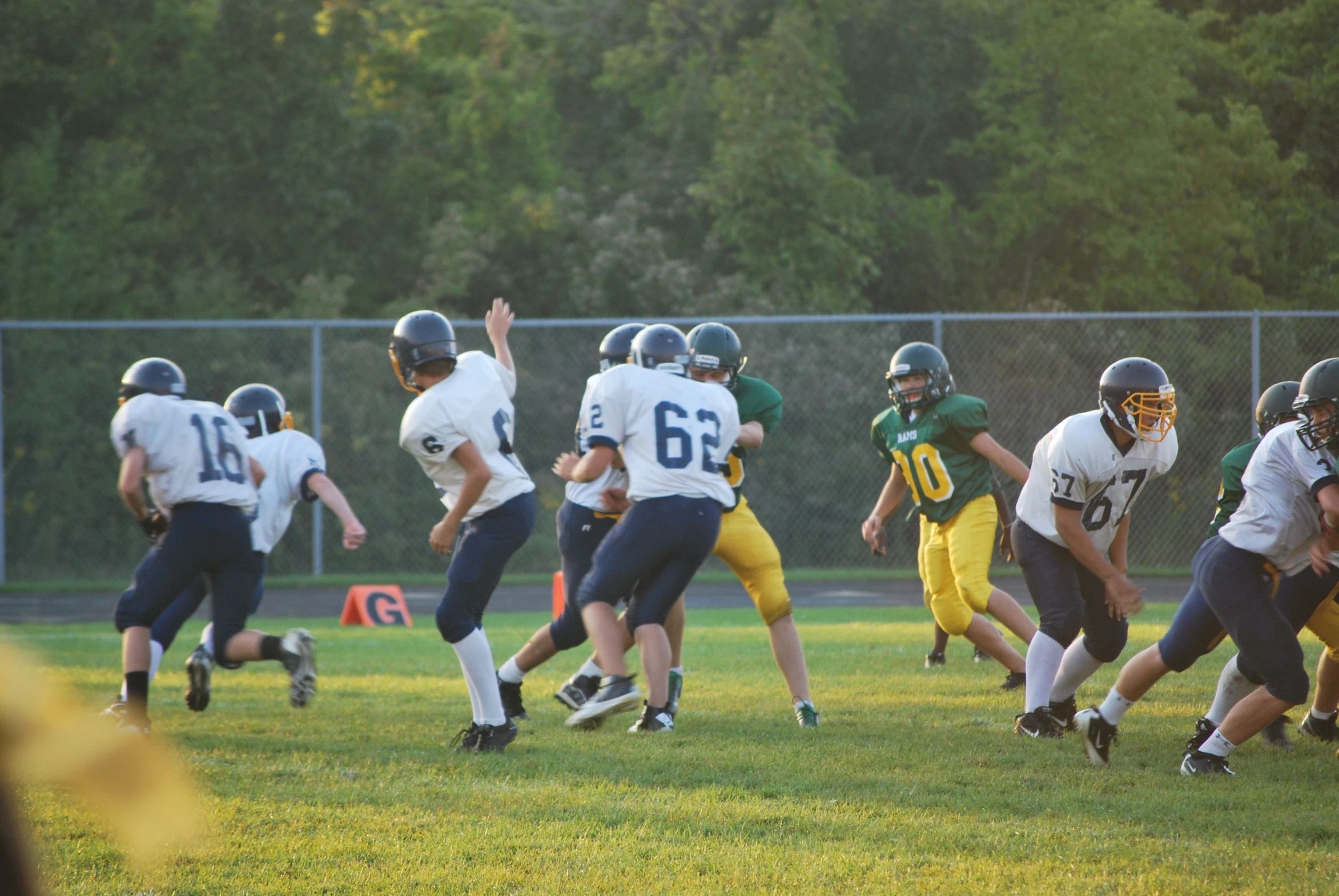 a team running with the ball on a football field