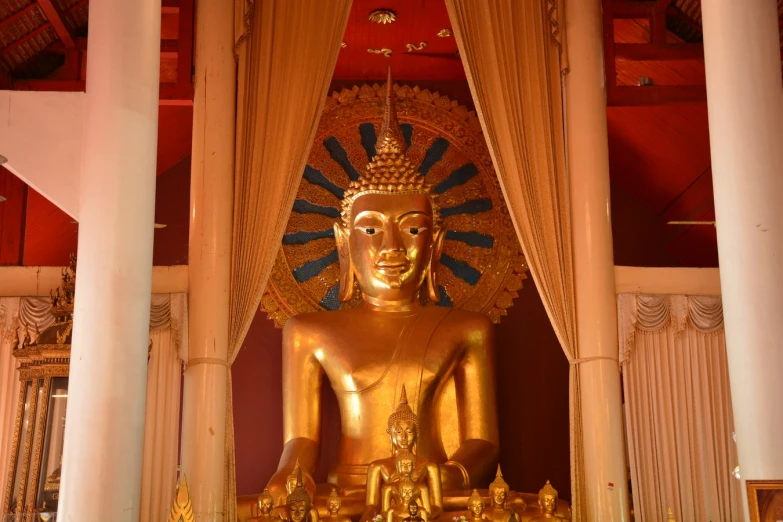 a golden buddha statue at an oriental shrine