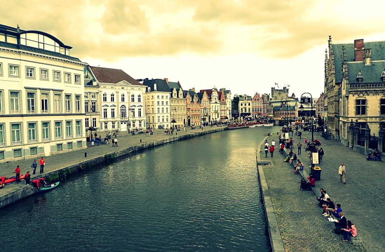 some people and some buildings by water