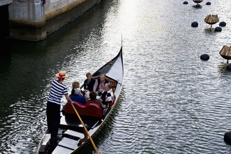 a small boat that is filled with people on the water