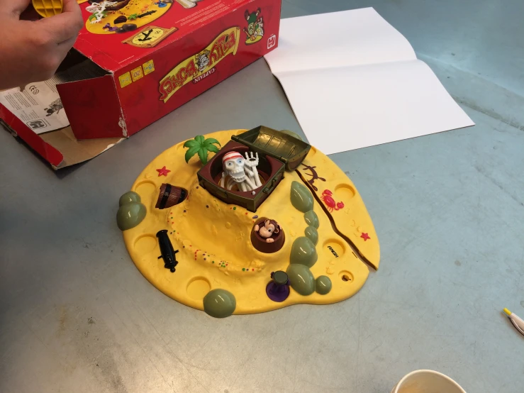 a table with a box and toy pirates in it