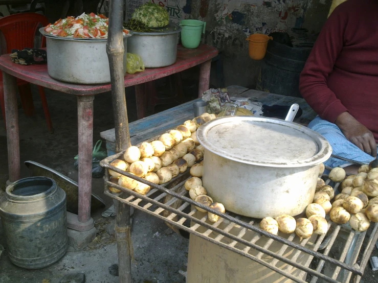potatoes roasting on a metal rack outside