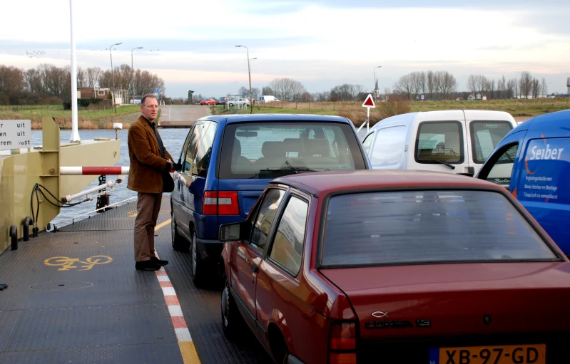 a man is talking to two other cars