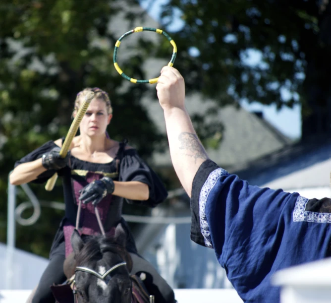 a man and woman are playing a game of hula hoop