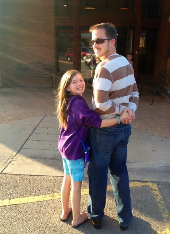 a woman emcing a man wearing sunglasses with a shopping bag on the ground