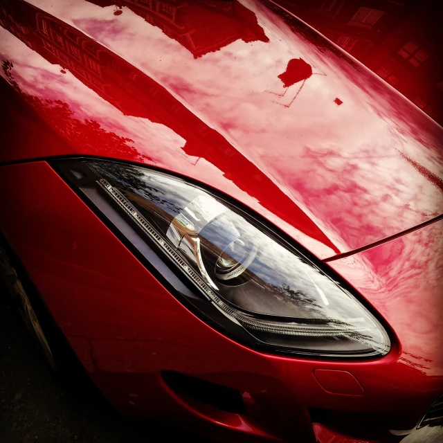 an image of a red car parked near a parking lot