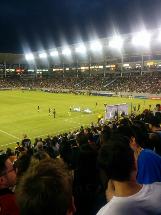 a soccer stadium filled with spectators and players