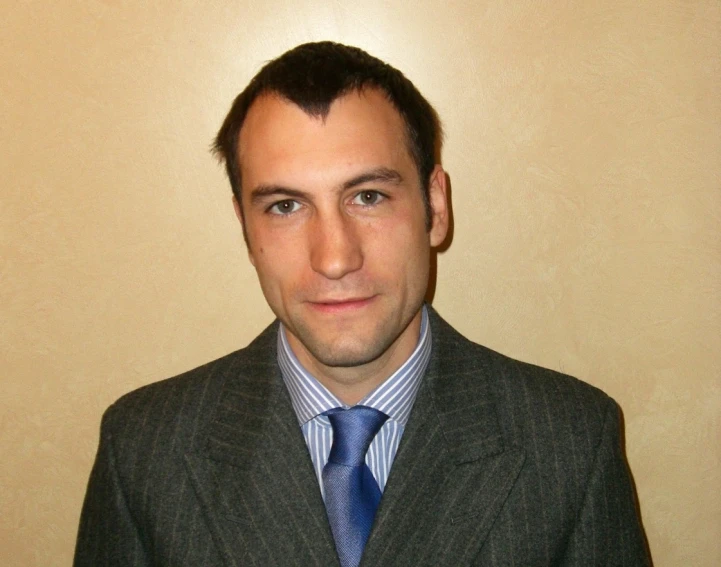 a man wearing a suit jacket and tie