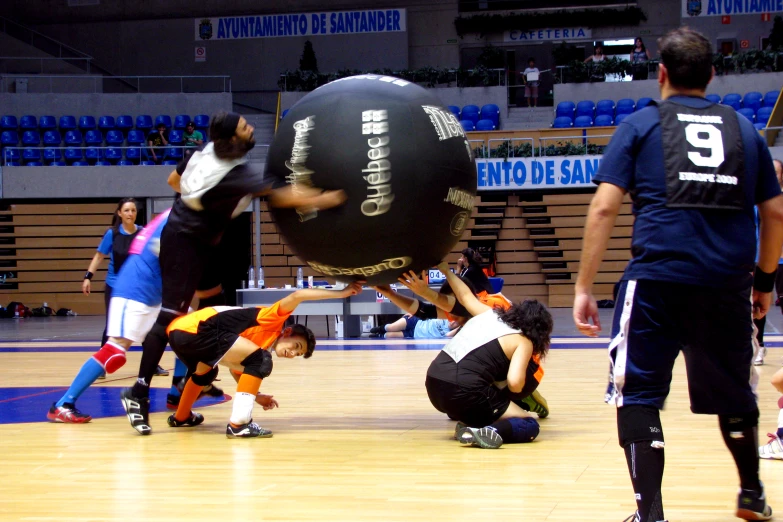 the ball is being lifted up on top of two players