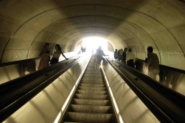 people are riding down an escalator and having fun