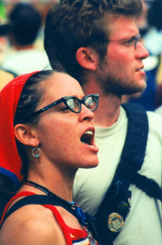 man and woman wearing red vests at outdoor event