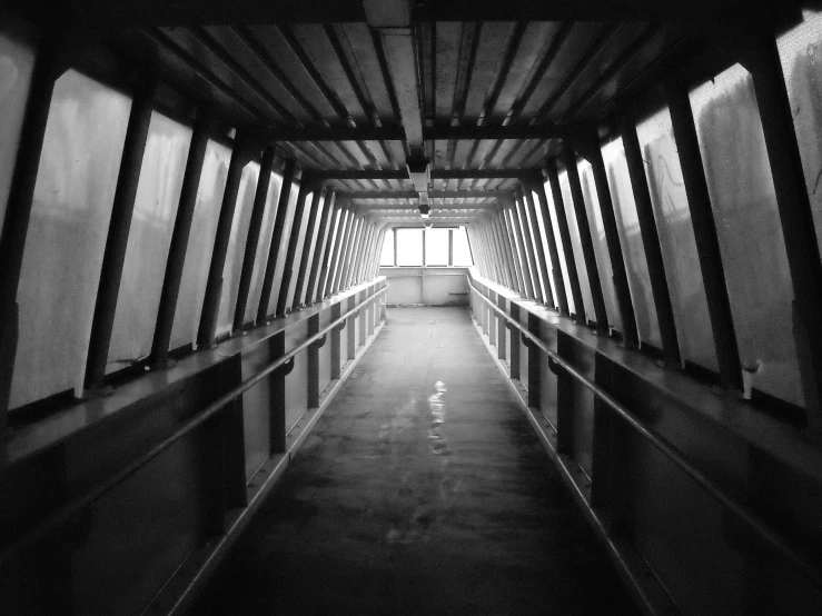 an empty hallway that has a big window on one side