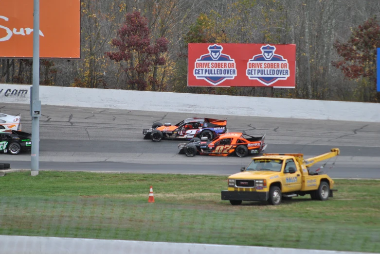 some very cute race cars on the track