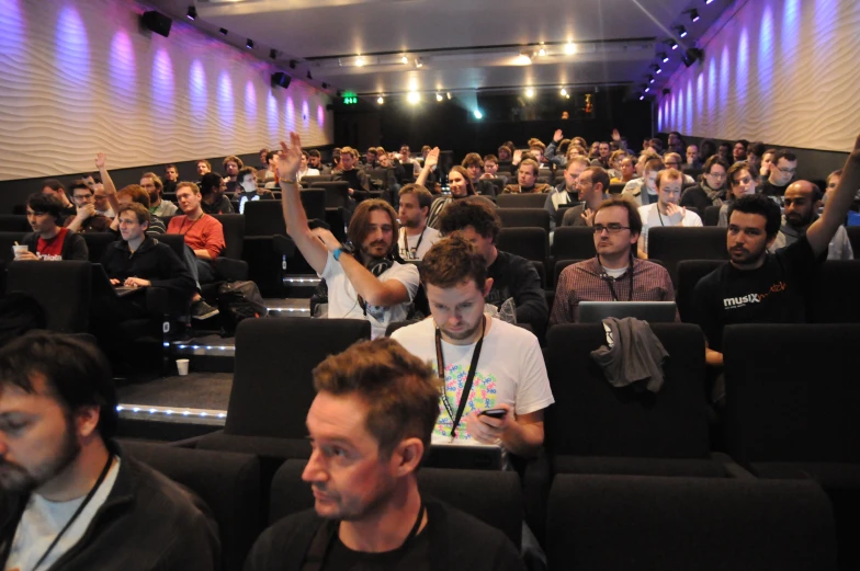 a crowded room with people and a microphone