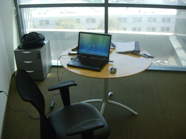 a desk with a laptop computer sitting on top of it