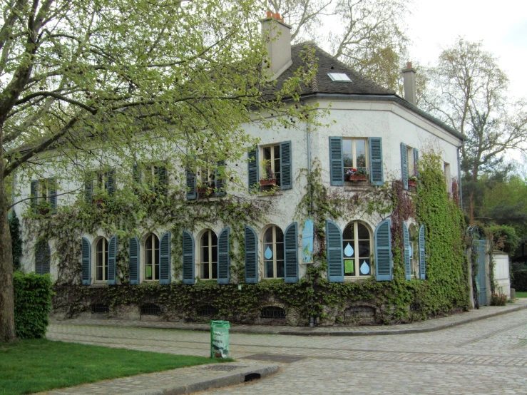 a white house with a green and blue window covering