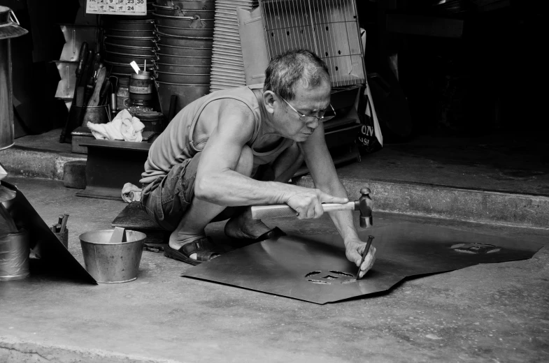 a man kneeling on the ground doing soing with his hands