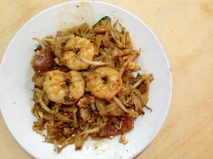 a plate full of rice and shrimp is seen here
