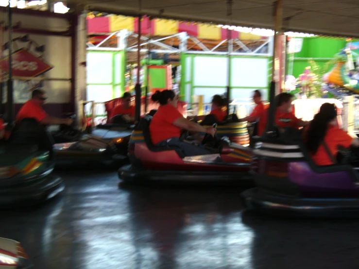 people ride bumper cars on the carnival, at a fun attraction