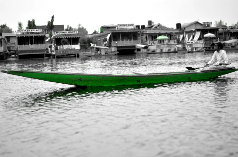 a person is sitting in a boat while on the river