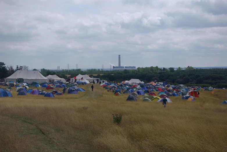 a lot of tents and some buildings in a field