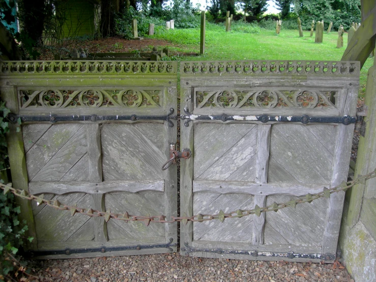 a stone fence and post on grass covered ground