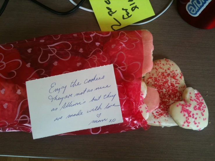 a bag of cookies with paper on top and notes on the back