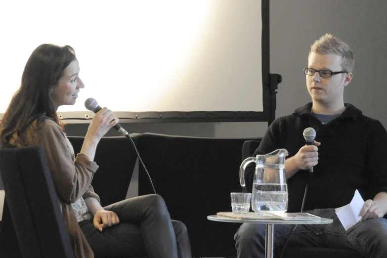 a man and woman are talking into microphones