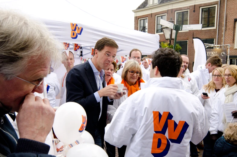 a group of people standing around a man blowing bubbles