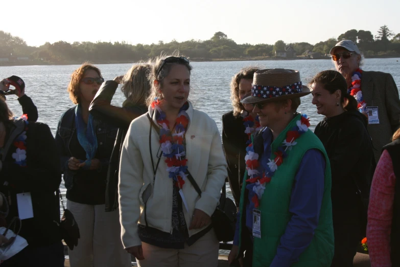 a man standing by the water wearing a tie