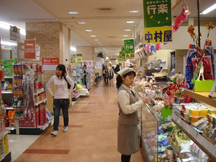 a woman is standing at a store with her hand in a bag