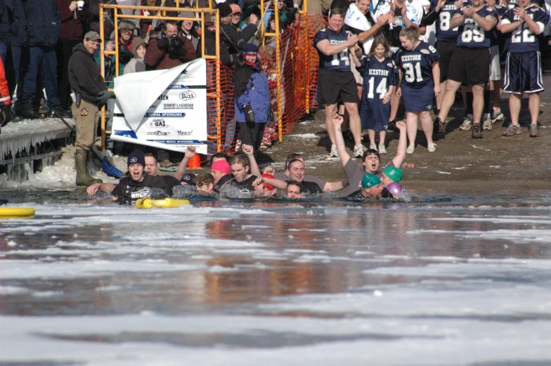 a group of men riding on the backs of rubber boats