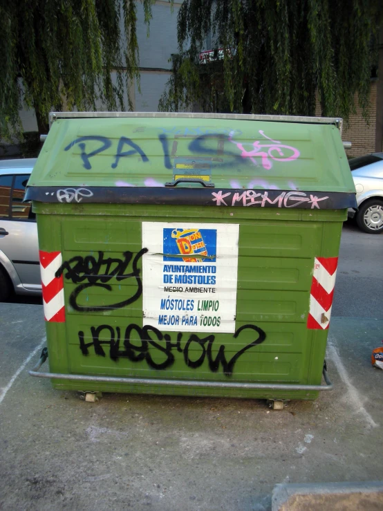 a trash can with a sign on top