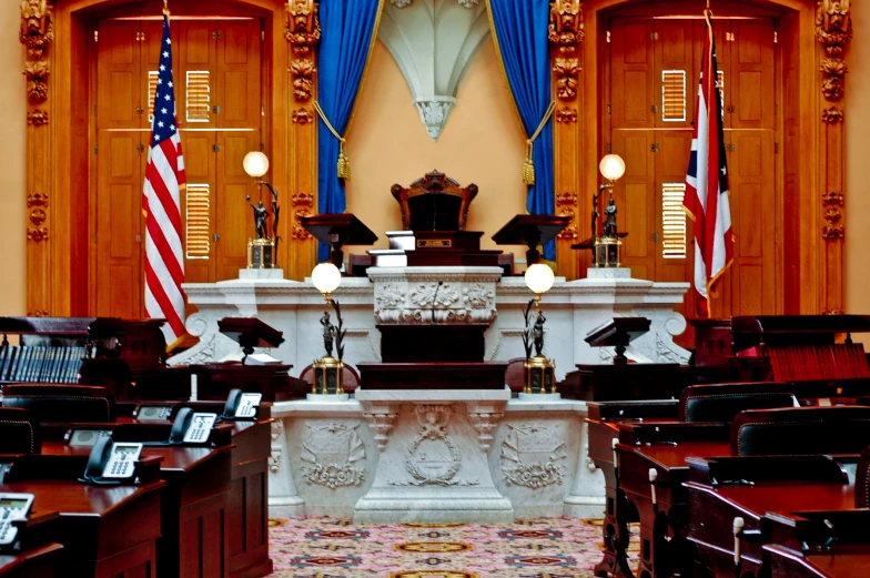 the courtroom room of a building with us flags in the room