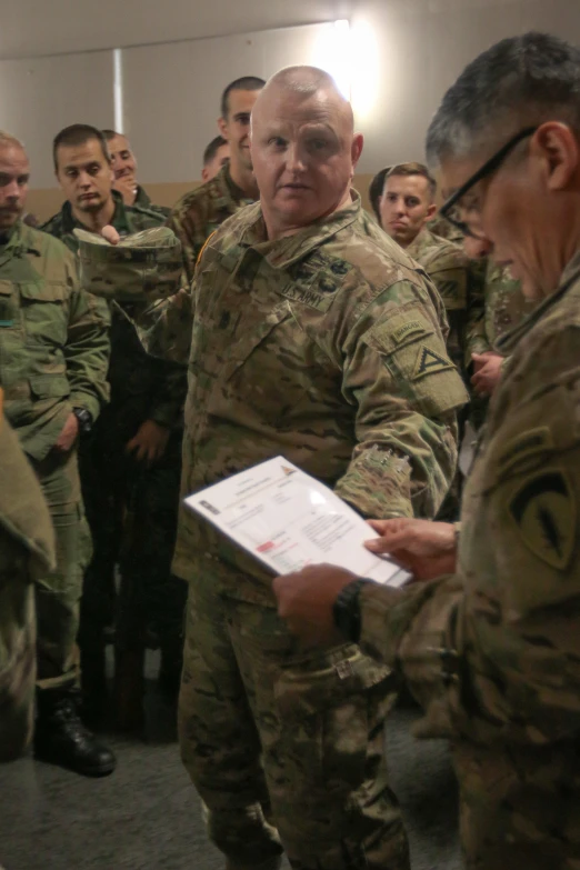 military men in uniform at a conference and talking