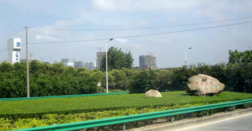 a view of the highway from a park with a large rock on the side of it