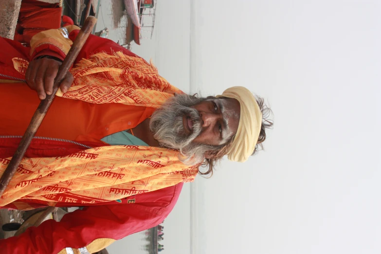 a bearded man with a hat and turban