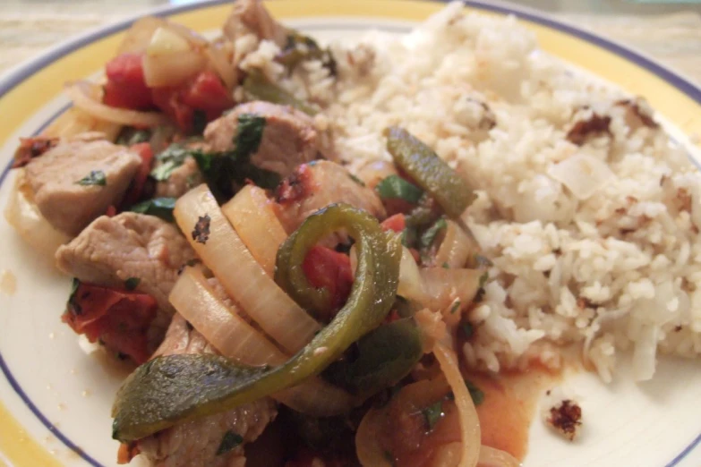 a yellow and blue plate with meat and veggies